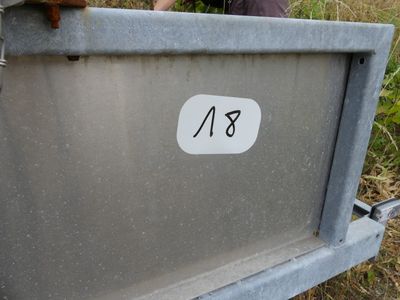 a man standing next to a metal box with a number on it