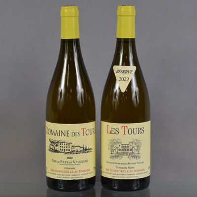 two bottles of wine sitting on top of a table next to each other