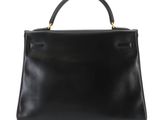 a black leather handbag on a white background
