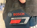 someone is holding a bosch cordless drill in their hand