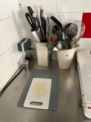 many kitchen utensils on the counter in this kitchen