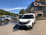 a white van parked in front of a building in a parking lot