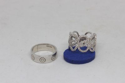 two silver rings and a blue ring on a white surface