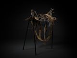 an image of a sculpture of a horse with a saddle on it ' s back