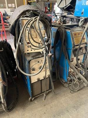 a lot of welding equipment in a garage
