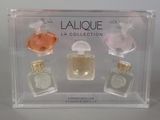 four bottles of perfume in a clear display case