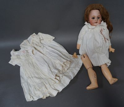 two dolls sitting next to each other on a gray surface