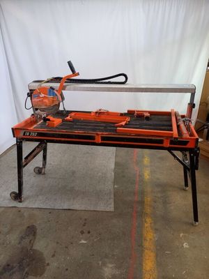 an orange and black table with a saw on top of it