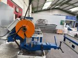 a machine that is cutting a piece of metal in a factory