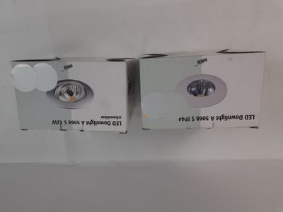two boxes of the same light are shown on a white surface