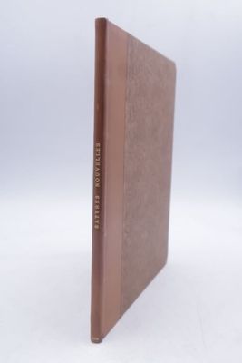 a brown book with a brown cover on a white surface