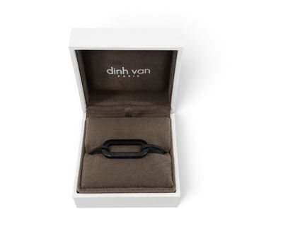 a close up of a watch in a box on a white surface