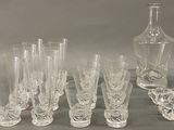 a lot of glasses and a decanter on the table