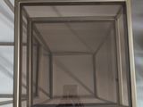a mirror in the middle of a room with a light coming through it