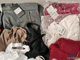 many different types of clothes and bags in a box