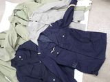 a pile of clothes on the floor next to a pair of scissors
