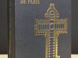 the front cover of a book with a gold cross on it