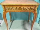 a small table with a wooden top on a white surface