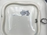 a white plate with a dragon on it sitting on a table