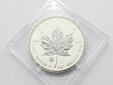 a close up of a coin in a clear box on a white surface