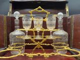 a wooden box with a glass set on top of it