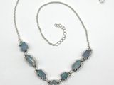 silver necklace with blue glass beads and a silver chain