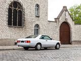 a white car parked on a cobblestone street