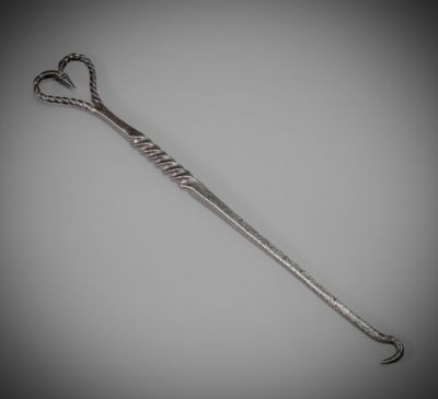 a very long metal handle with a knot on it