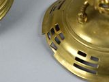 two gold colored candles that are sitting on a table