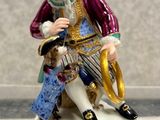 a figurine of a man sitting on top of a table