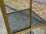 a glass table with a gold frame on it