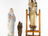 three figurines of the virgin and child on a easel