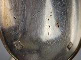 a close up of a silver spoon with a spoon handle