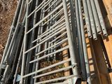 a pile of metal pipes sitting on top of a pile of wood