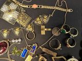 many different types of jewelry on a black surface