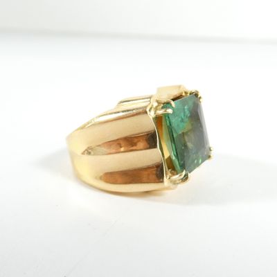 une image représentant une bague en or sertie d'une tourmaline verte
