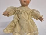 a small doll that is sitting on top of a rock