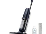 a close up of a vacuum cleaner with a cleaning cloth and a bottle of cleaner