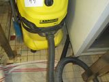 a yellow and black vacuum sitting on a tiled floor