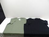three t - shirts are sitting on a white table in a room