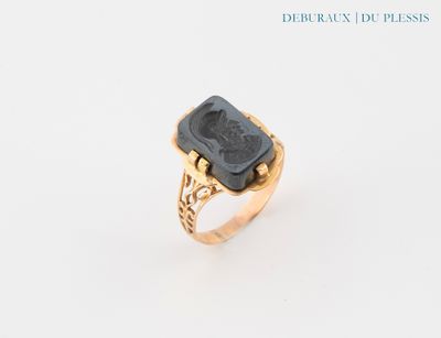 an image of a gold ring with a black stone in the center