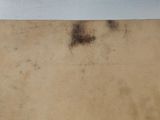 a brown piece of paper on a white surface