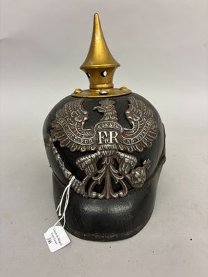 an old black and gold helmet with an eagle on it