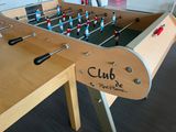 a table with a foosball on it in a room