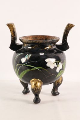 a black and gold vase with flowers on it