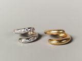 two gold and silver rings sitting on top of each other