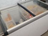 a freezer with food inside of it in a kitchen
