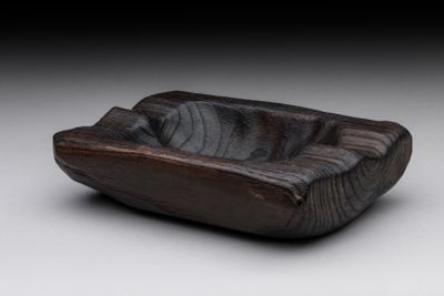 bowl made of wood on a white surface with a black background