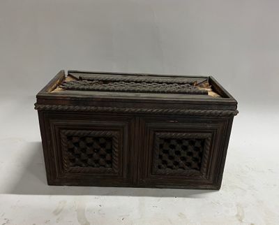 an old wooden box with a decorative design on top of it