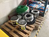several cans of paint on a pallet in a warehouse